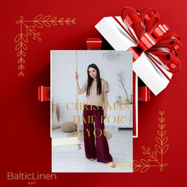 On a red background, a woman wearing a Baltic Linen linen suit—pants and blouse—invites you to dress elegantly during the Christmas season.