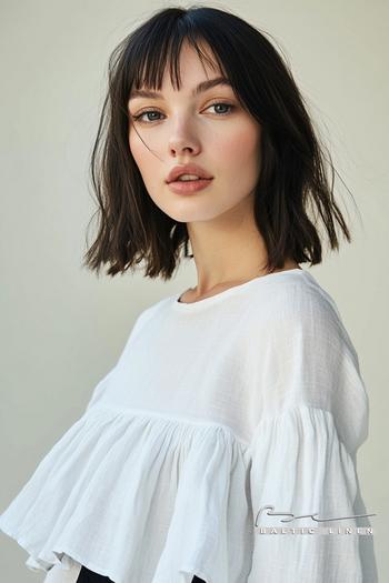 Stunning jet-black bob hairstyle with asymmetrical ruffle top outfit