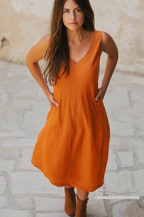 Gray linen dress close-up against beautiful pink granite rocks