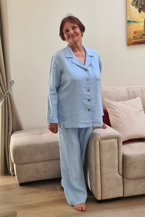 Senior lady dressed in a two-piece linen sleepwear set featuring relaxed-fit pants and a soft buttoned top.