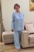 Senior lady dressed in a two-piece linen sleepwear set featuring relaxed-fit pants and a soft buttoned top.