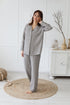 Relaxed-fit linen pyjamas for women and men with comfortable pants and a front-buttoned jacket, offering style and ease of movement.