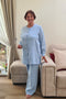 Senior lady dressed in a two-piece linen sleepwear set featuring relaxed-fit pants with elastic and a soft buttoned top.