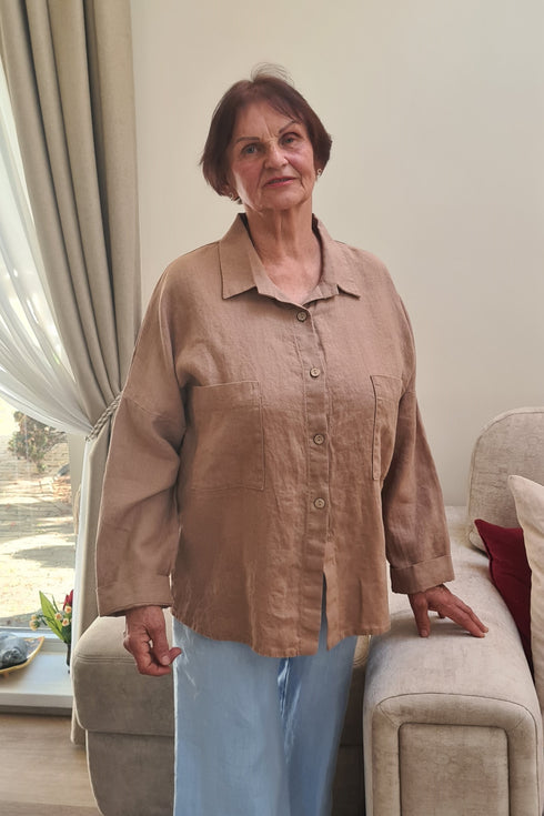 Senior lady dressed in the comfortable and stylish “KARINA” pajama top, designed with soft material and easy button fastening.