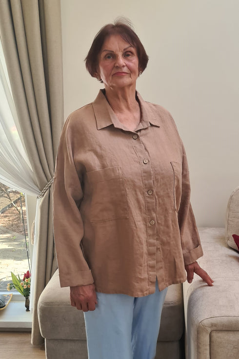 Elderly lady in a cozy beige pajama shirt “KARINA” with buttons and pockets, perfect for relaxed moments.