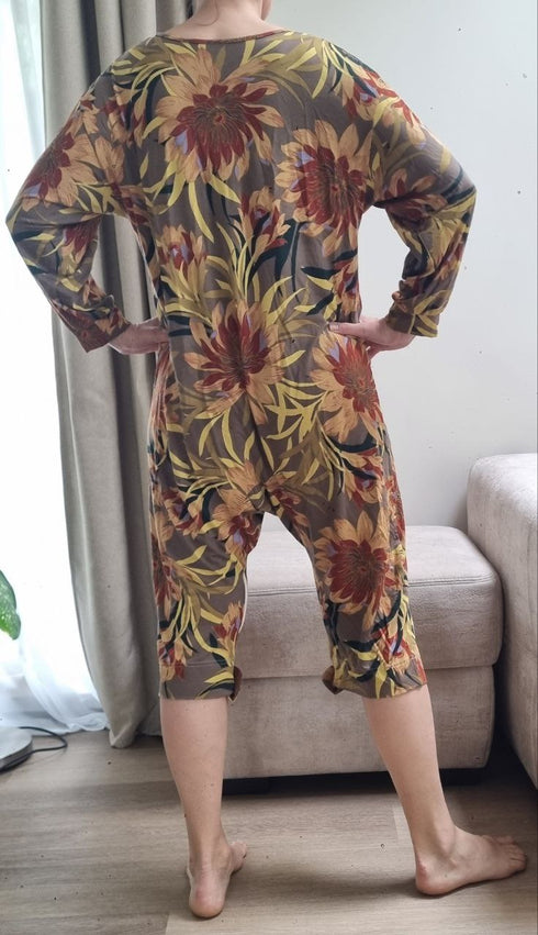 Lady dressed in a vibrant geriatric pajama with floral print, offering comfort and practicality for elderly wearers.