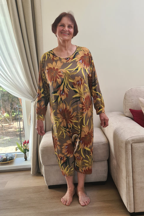 Senior lady dressed in a vibrant geriatric pajama with floral print, offering comfort and practicality for elderly wearers.