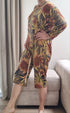 Woman wearing adaptive geriatric pyjamas with bright floral design, ideal for comfort and dignity at home or care settings.