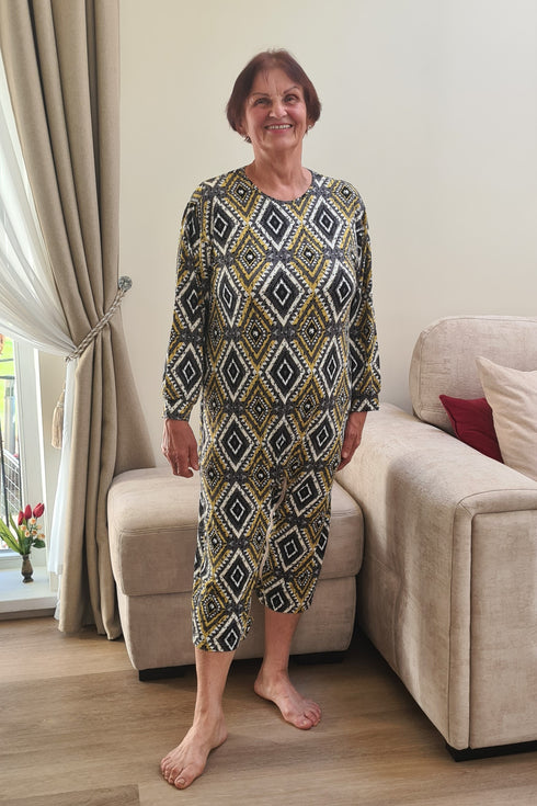 Elderly woman wearing a patterned geriatric pyjama designed for seniors, featuring soft fabric and easy-to-wear comfort.