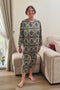 Elderly woman wearing a patterned geriatric pyjama designed for seniors, featuring soft fabric and easy-to-wear comfort.