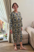 Comfortable and stylish geriatric pajamas for seniors, modeled by an elderly woman, ideal for home and care settings.