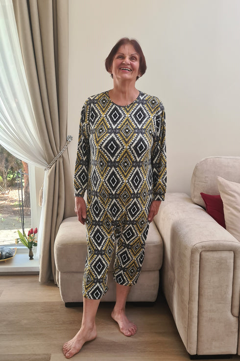 Senior woman in vibrant patterned geriatric pyjamas, designed for comfort, dignity, and ease of dressing.