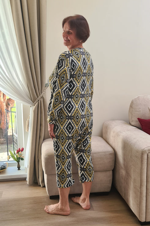 Elderly woman wearing soft geriatric loungewear with diamond pattern, perfect for seniors needing adaptive sleepwear.