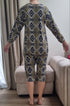 Woman dressed in patterned geriatric pyjamas, designed to ensure comfort, warmth, and ease of movement.
