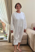 Senior woman dressed in practical geriatric pajamas with long sleeves, created for easy movement and all-day comfort.